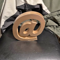 This item is a 9-inch gold-colored wooden '@' sign decor.