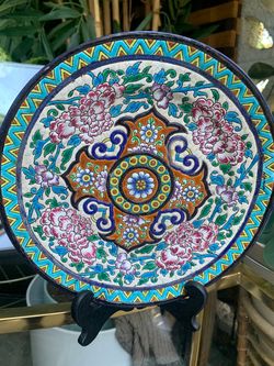 An antique ceramic plate with the Longwy pottery backstamp.