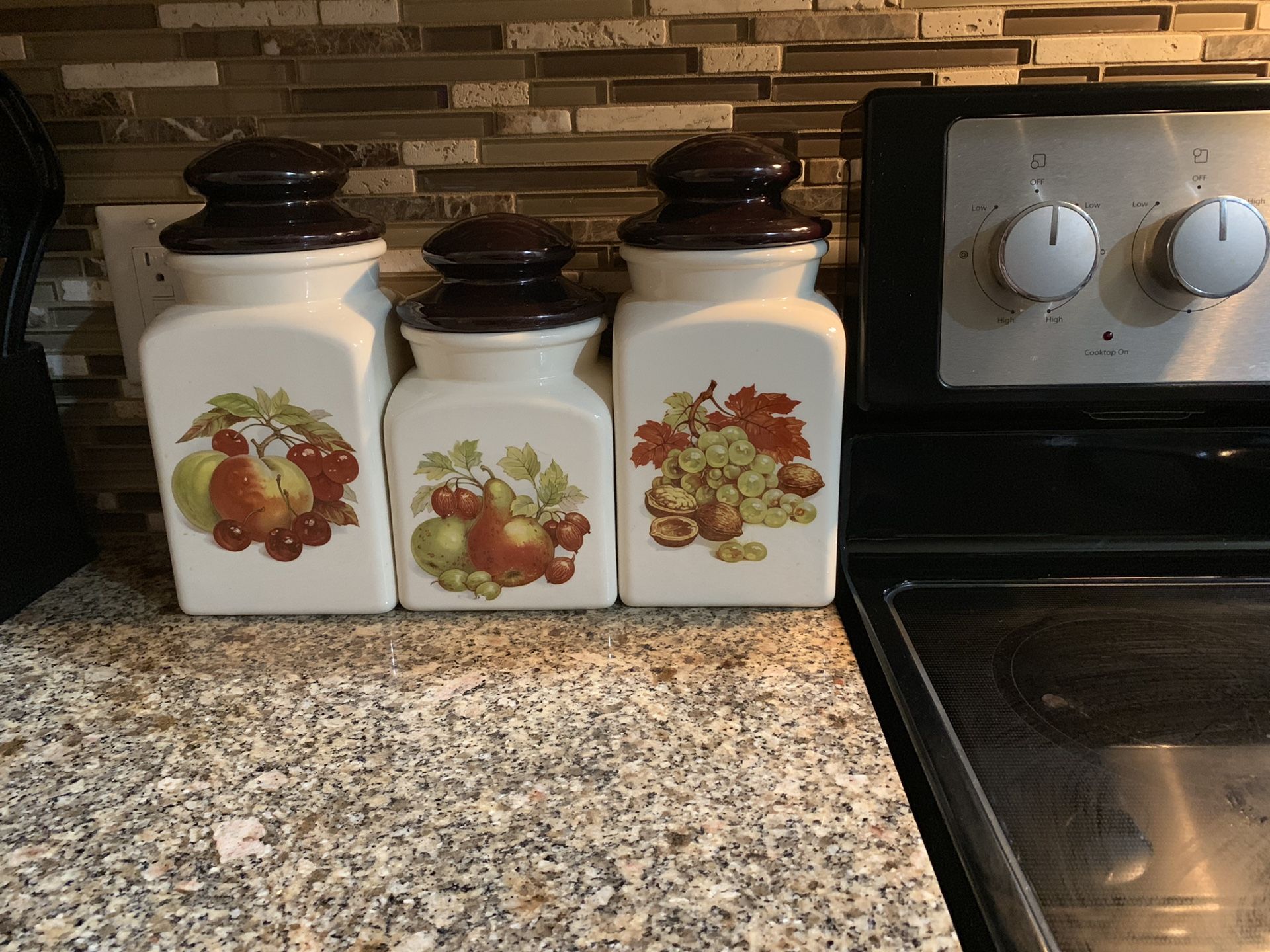 Set of three glass or maybe ceramic canisters/jars