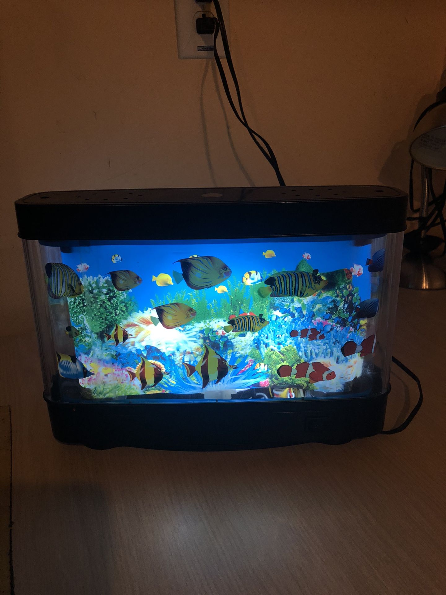 Small fish tank (it gives illusion of fish moving in it )no water of real fish needed
