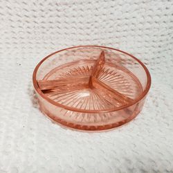 Depression pink glass candy dish ( edge a a small nik)  Good condition and smoke free home.  Measures 6 1/2" W X 1  1/2" D. 