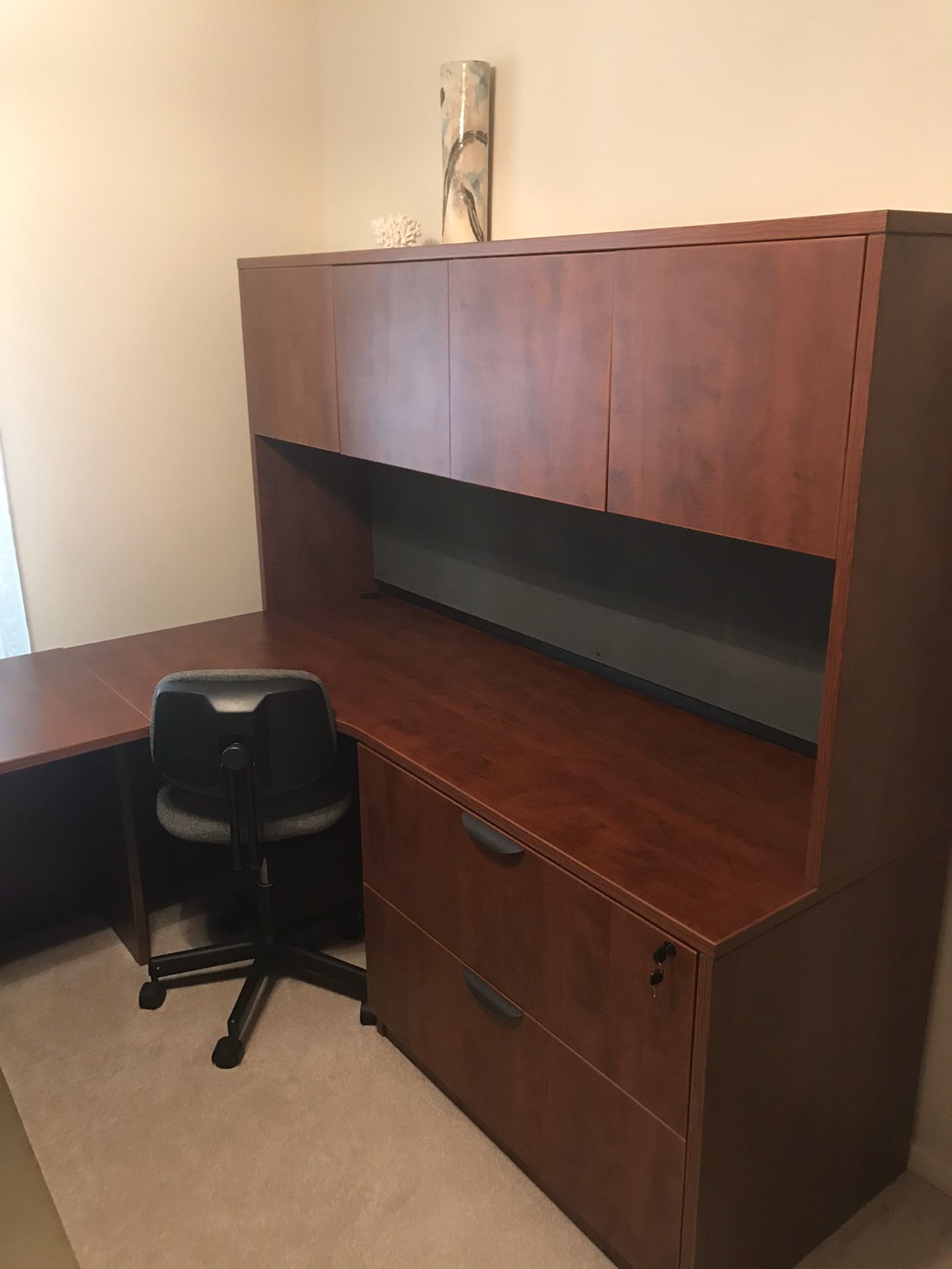 Office desk and chair with locking file drawers.