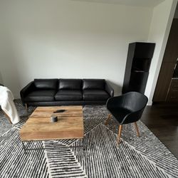 Two CB2 Black Accent Chairs With Wooden Legs 
