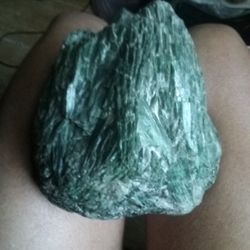 I Have A Very Rare Rock That I  Came Across It's Green With Cristal  Like Shards In It  Crystals Look Like  So I Am Not Sure 