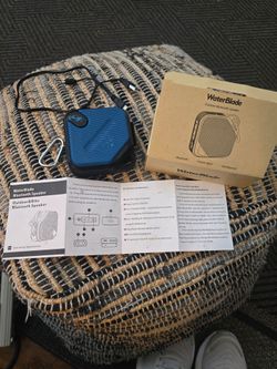 WATERBLADE Compact blue wireless speaker with black trim. Textured grille design outdoor and bikes. Includes USB charging cable and box. Lightweight a