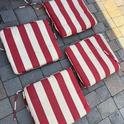 4 Piece Outdoor Patio Furniture Cushions By Sunbrella in red and white stripes   Located in concord  Very good condition  No damages  Measures 19” x 2