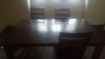Nice black dining room kitchen table with 3 leather padded ladder back chairs. 66" long, 42" wide, 30" tall