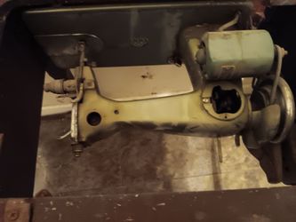 Royal Sewing machine  sits in a cabinet  needs alot of work