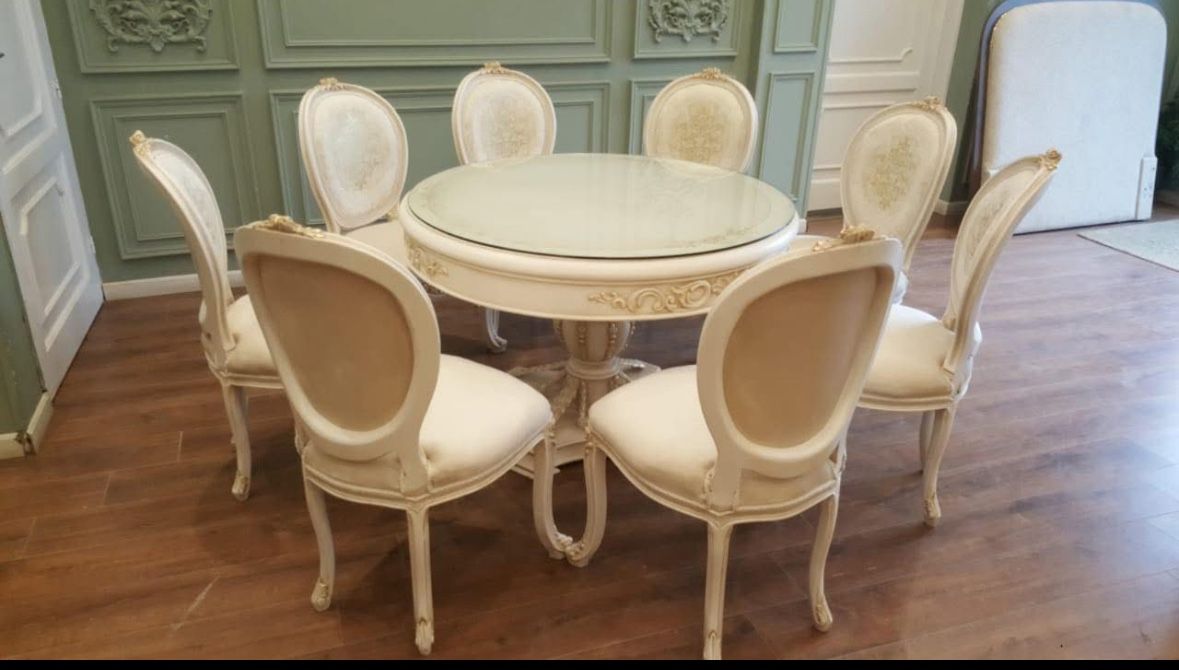 Rococo Dining Set LOOK UP This is a Rococo-style dining set with a round glass-top table and six chairs. TIME PERIOD Late 20th/Early 21st Century ORI