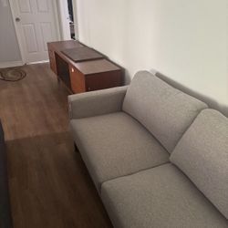 Sectional Couch With A Pillows And An Ottoamn Included