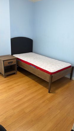 Twin bed with mattress and nightstand