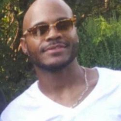 Charcoal grey sectional with matching ottoman.