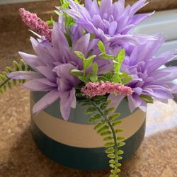 fake purple flowers in round pot