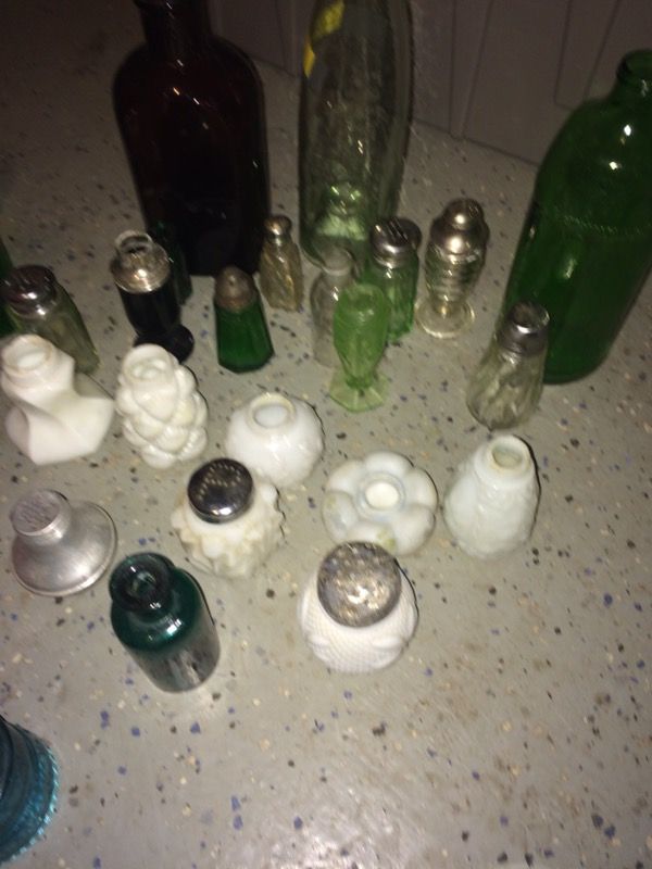 Assortment of antique salt and pepper shakers along with bottles and ink well