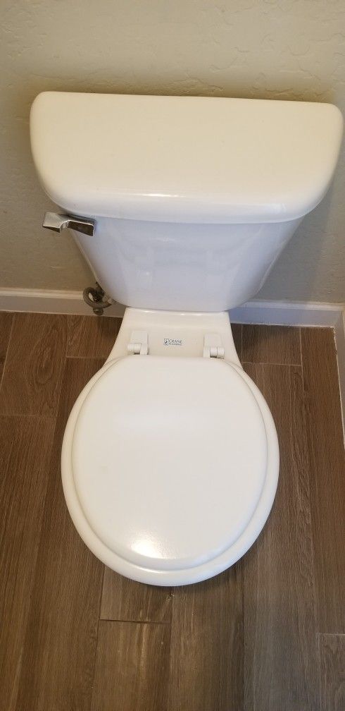 White Toilet With Round Seat. Standard Height. Crane Plumbing