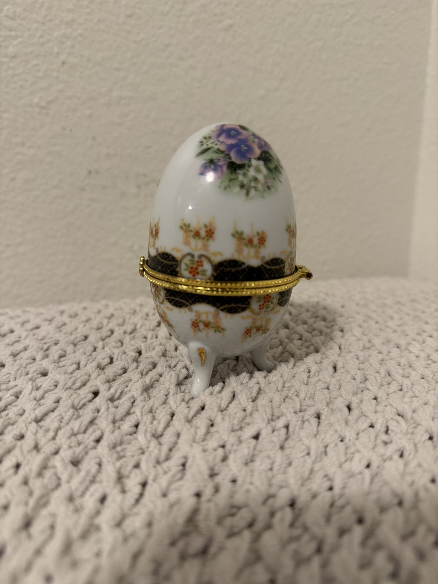 Vintage egg-shaped porcelain trinket box with hinges, multi-colored, with a floral print