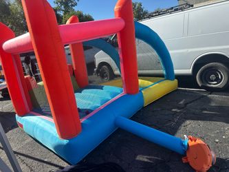 Naice inflatable bounce house with an attached slide and a mesh-enclosed jumping area