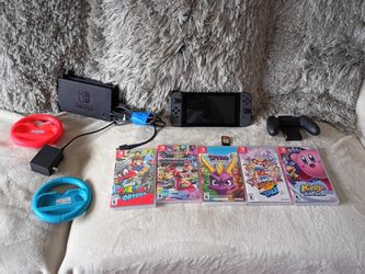 Nintendo Switch console with Joy-Con controllers, games, and accessories