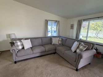 Grey sectional with pillows