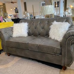 Gray chesterfield style loveseat