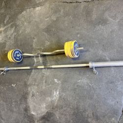 45lbs Olympic 7ft Bar And Curling Bar With Some Weights