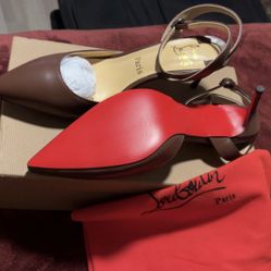 Christian Louboutin Hot Chick slingback kitten heel in brown leather with the iconic red lacquered sole. 