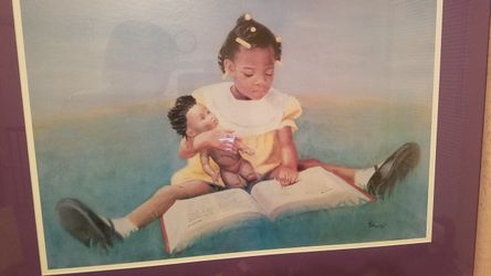 Little girl reading picture in picture frame