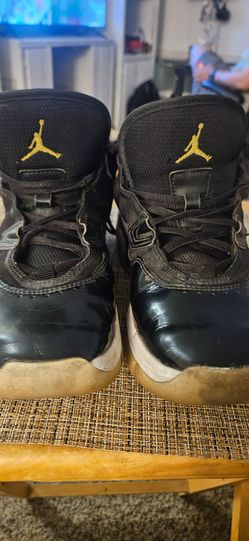 Air Jordan 11 Black and Gold Sneakers