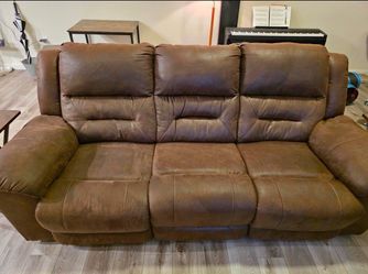 Light brown three seater recliner couch.