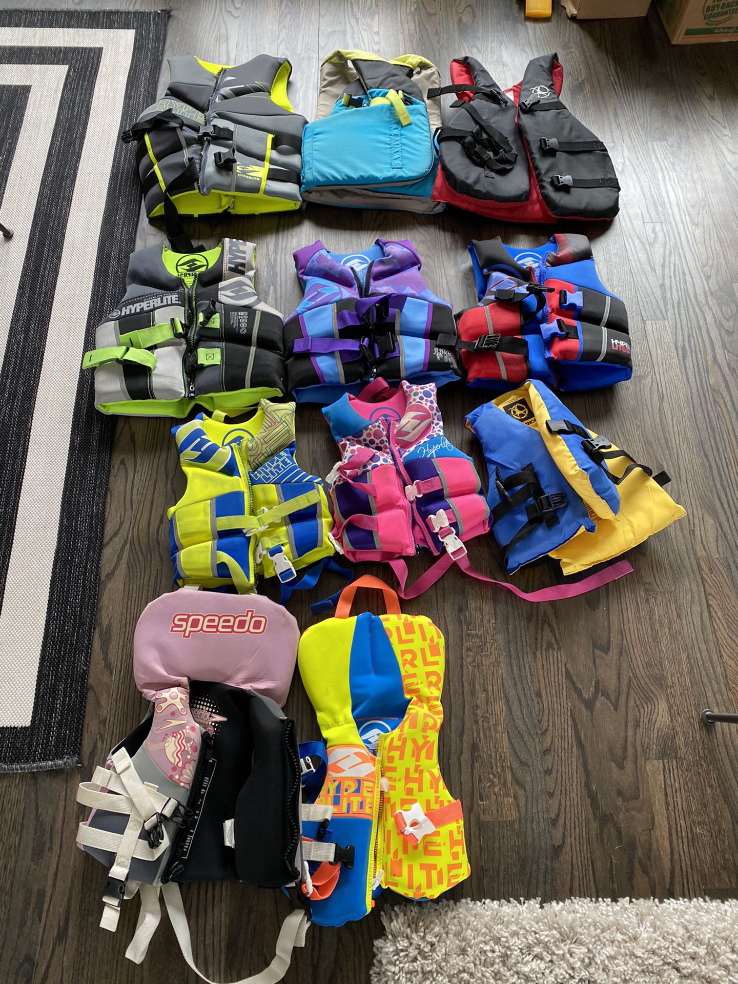Assorted life jackets — adult, youth, child, infant