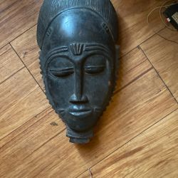 vintage, hand-carved wooden African mask, specifically a Baule or Yohouré "Mblo" portrait mask from the Ivory Coast. 