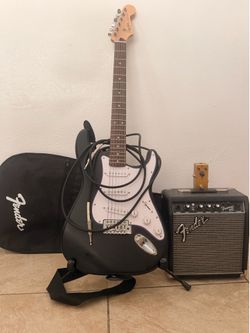 Squire Stratocaster electric guitar , phantom 10g amp, distortion pedal, guitar stand and guitar bag