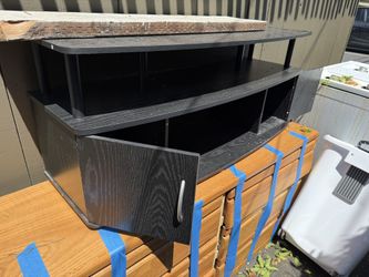 Black wooden TV stand with shelves and cabinet