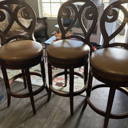 I'm selling 3 bar stools; they are tall and swivel, of very good quality. Solid wood and genuine leather.