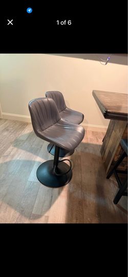 Two gray leather chairs