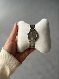 This is a Gucci G-Timeless watch with a stainless steel bracelet, gray, silver, brown