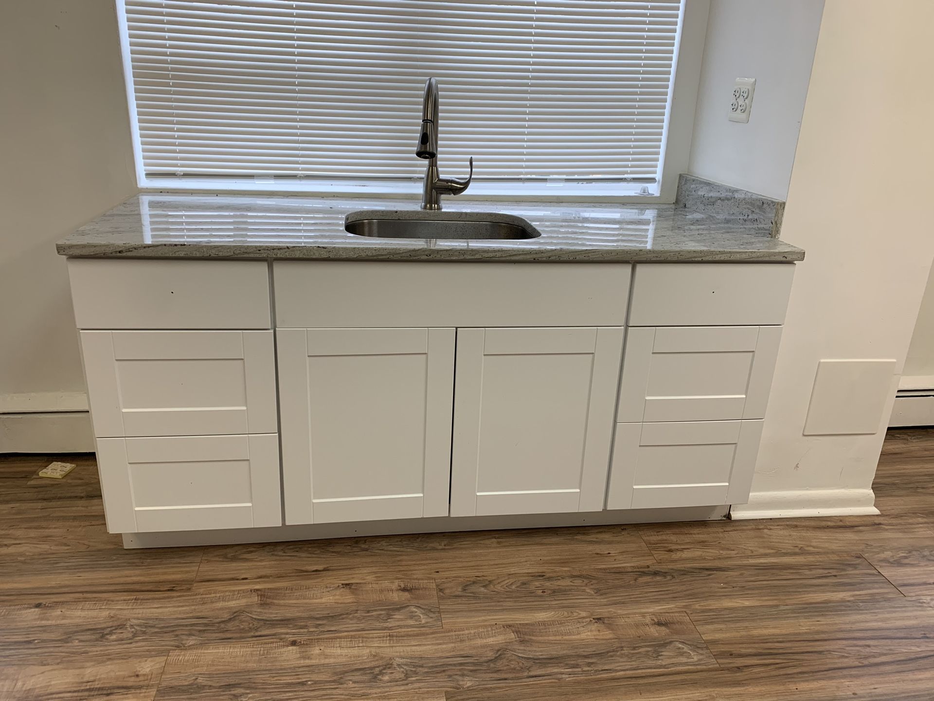 Base cabinet with granite countertop and sink