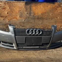This is a used front bumper cover for an Audi A4 (B7 generation, 2005-2008 model years) or potentially an Audi A6 (C6 generation). 