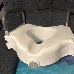 Raised toilet seat with handles