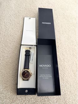 Beautiful unisex movado watch with original box, accessories and brand New battery. (HURRY BEFORE ITS GONE!)