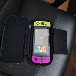 Nintendo switch with controllers and games and joy stick charger