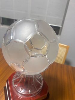 Crystal soccer trophy on wooden base