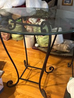 Wrought  iron  glass top dining table 4 feet round 42 in tall. 6  matching chairs. 31 in high