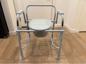 A deluxe steel drop -arm commode