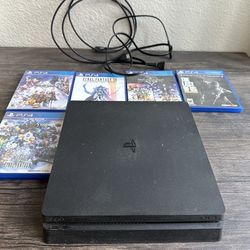 PlayStation 4 slim with games, cables