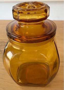 Amber glass jar, air tight lid, 5”wideX7 1/2” tall.