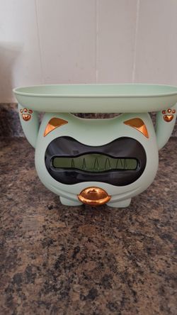 Cat tissue dispenser features a top tray for storage - light green