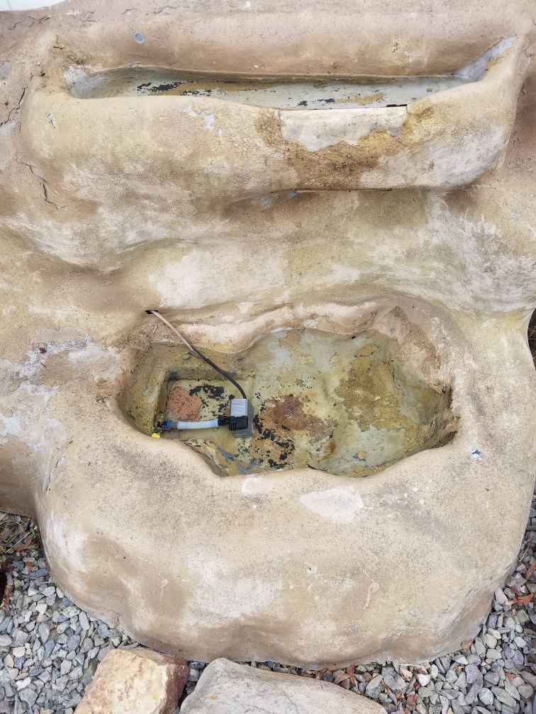 Fiberglass waterfall fountain. Works great/ good for fish/ not heavy. Easy to carry/ new hose/ comes with a pump