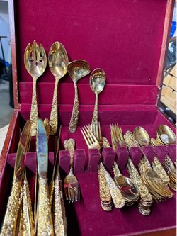 Gold silverware set in wood box