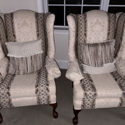 two white comfy chairs with pillow